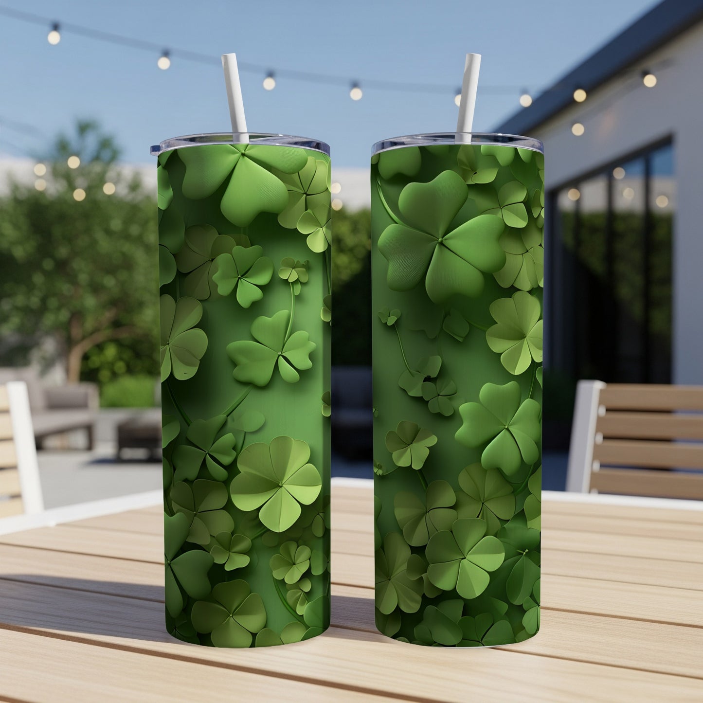 Two green tumblers with shamrock designs sit on a table outdoors.