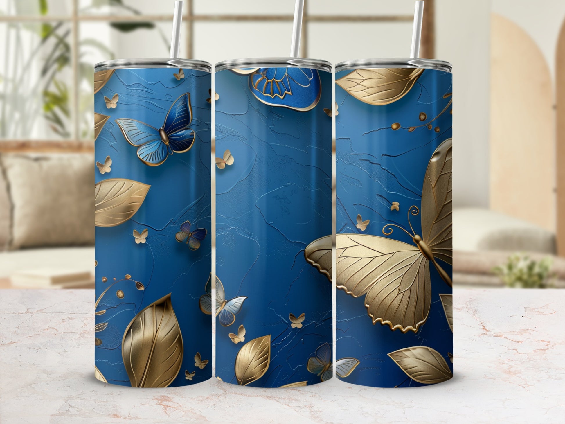Blue tumbler with gold butterflies and leaves, textured background.