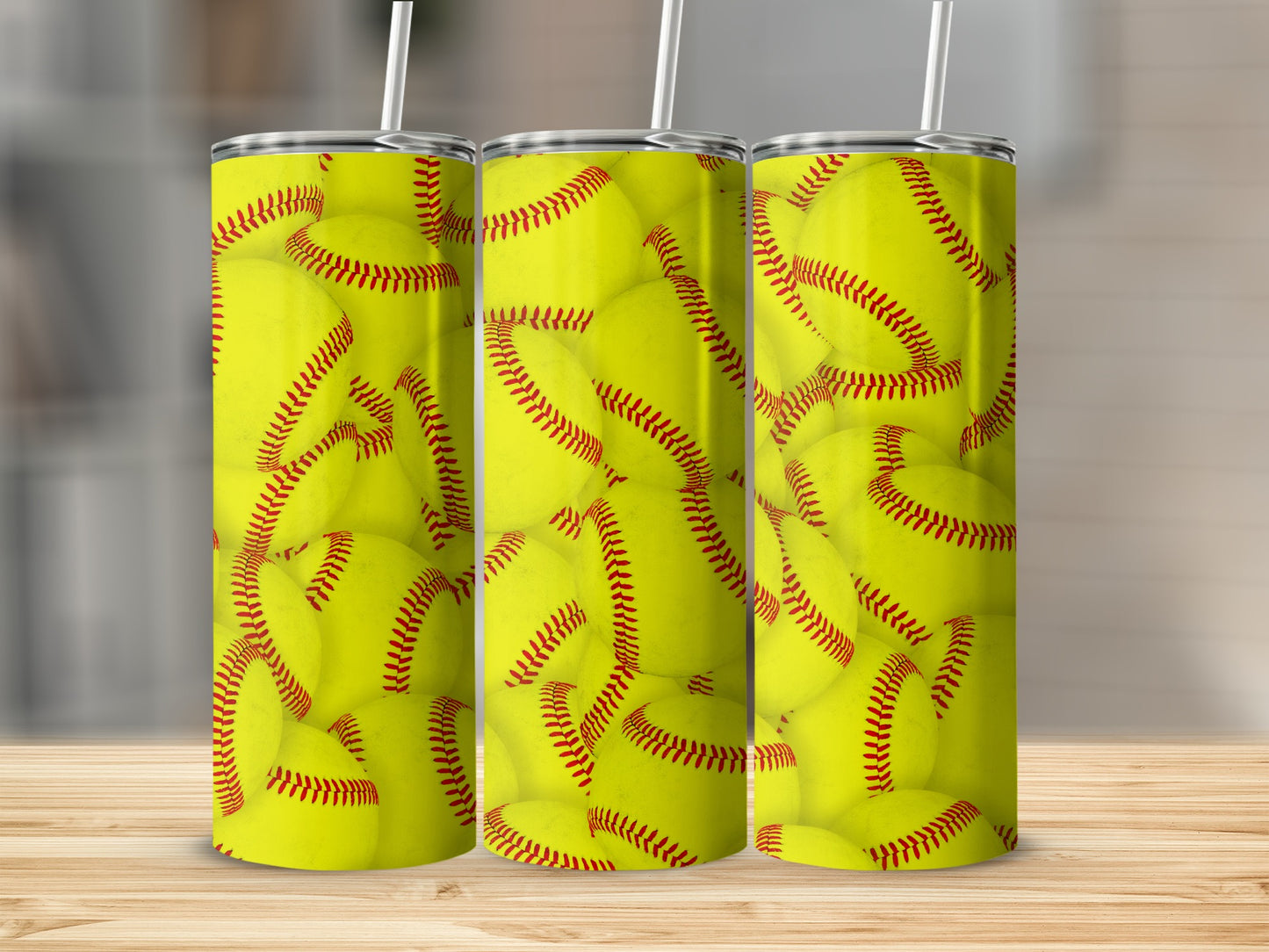 Three tumblers with a pattern of yellow softballs with red stitching.