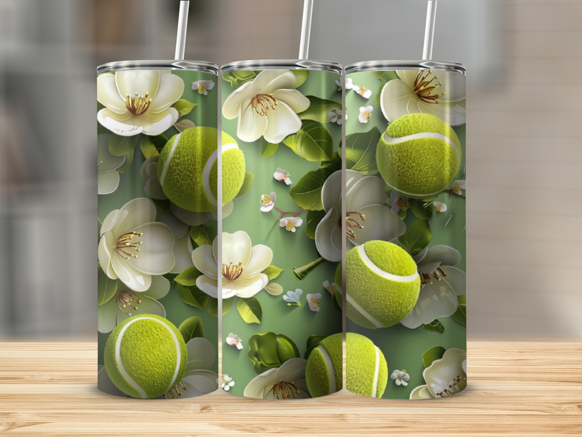 Tennis balls and magnolia flowers on a tall, cylindrical tumbler.