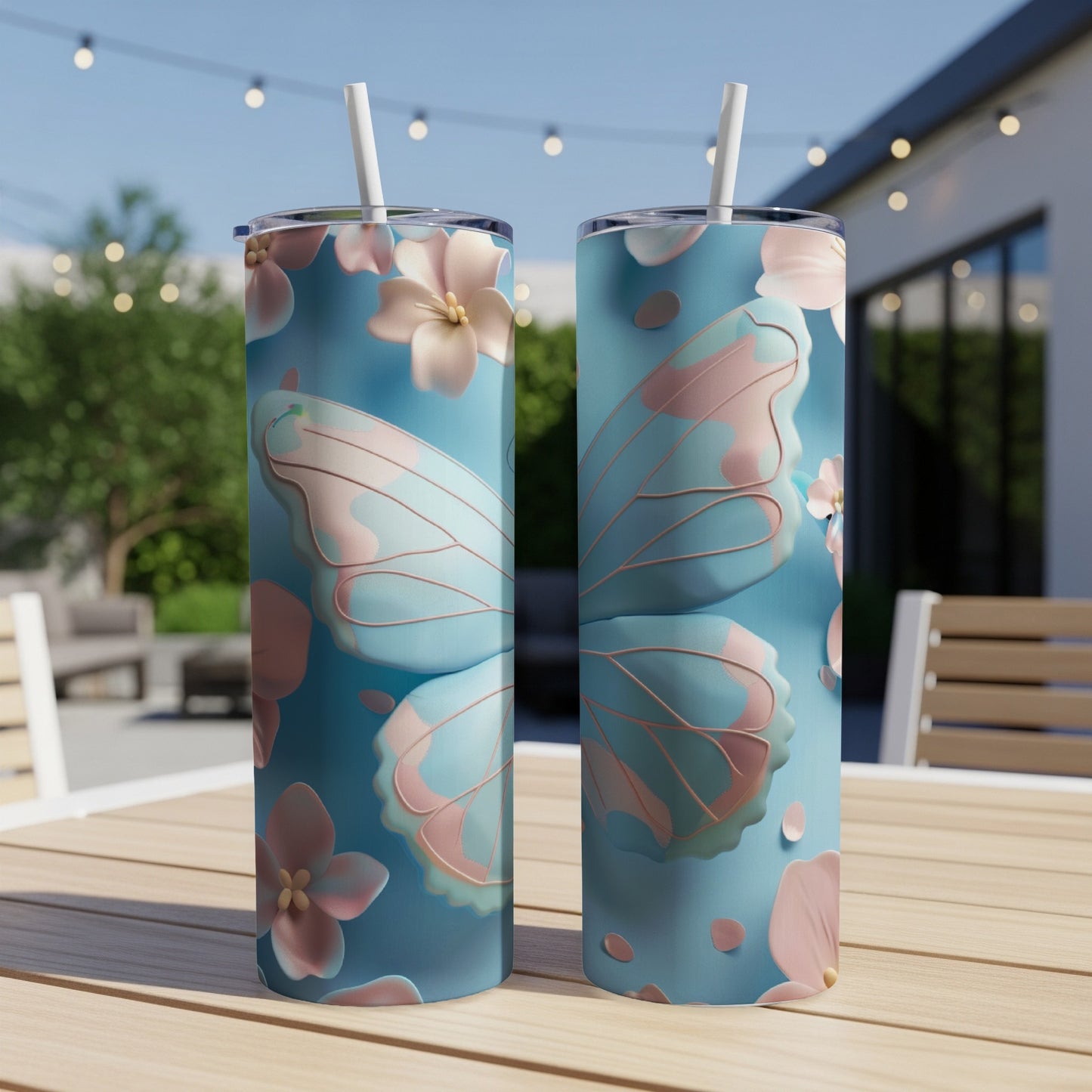 Two tall tumblers with a pastel blue butterfly wing and flower design.