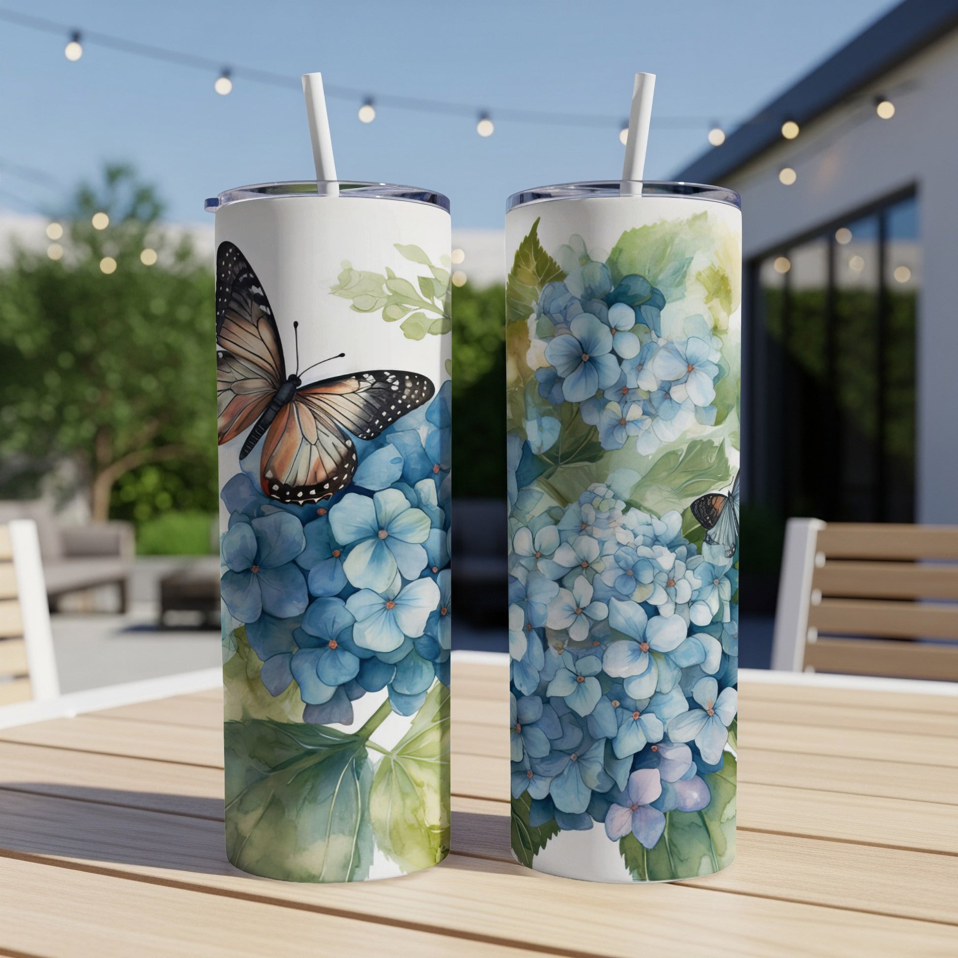 Two tumblers with hydrangea and butterfly designs, one with a prominent butterfly.