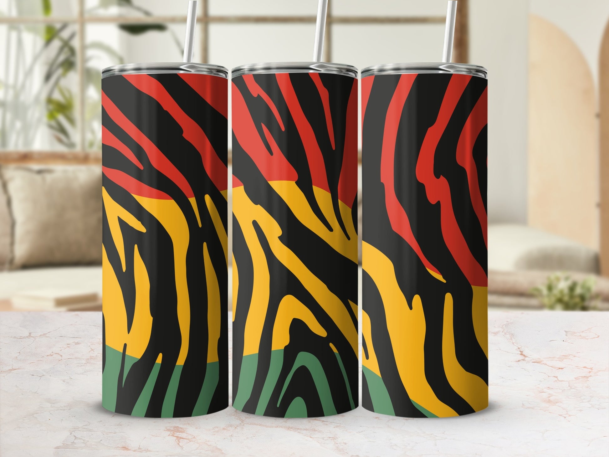 Three tumblers with red, yellow, black, and green wavy stripes and straws.