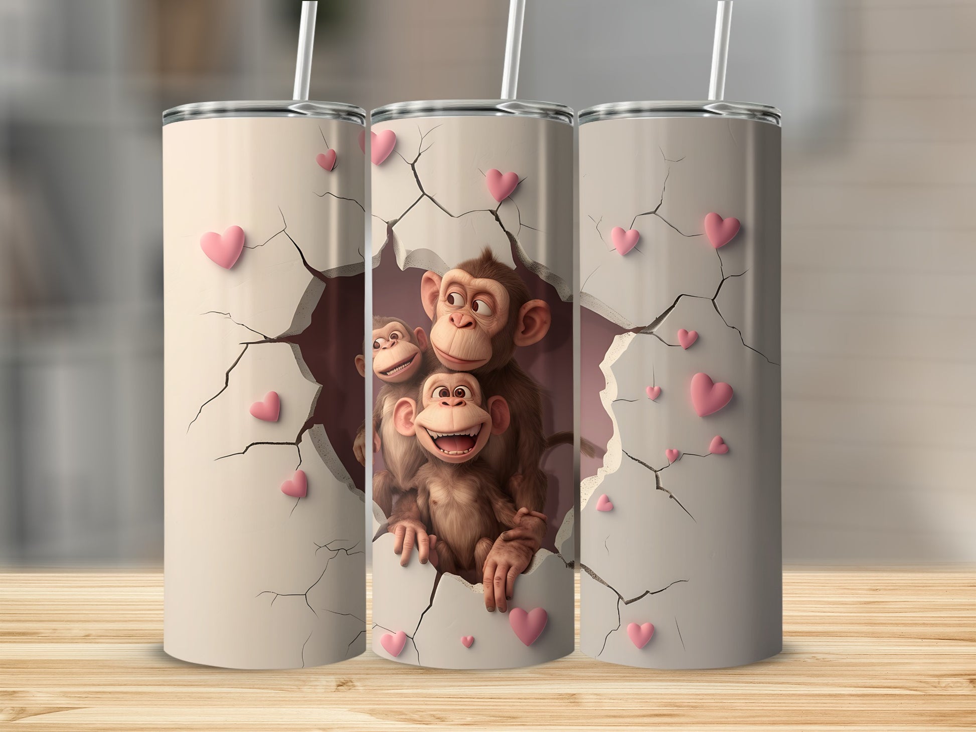 Three tumblers with monkeys peeking through cracked hearts.