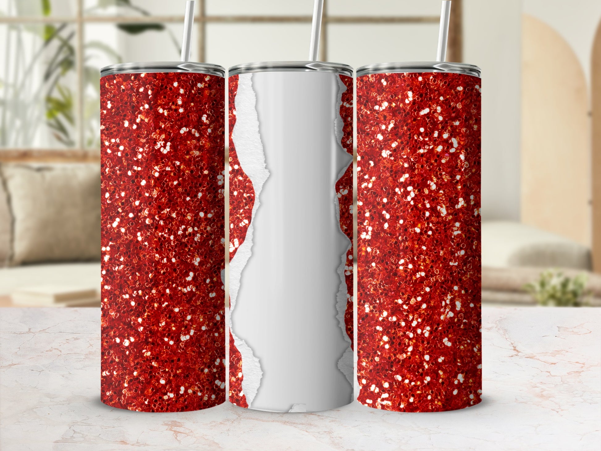 Three red glitter tumblers with white torn paper effect on a marble surface.