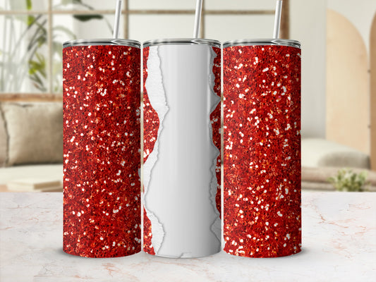Three red glitter tumblers with white torn paper effect on a marble surface.