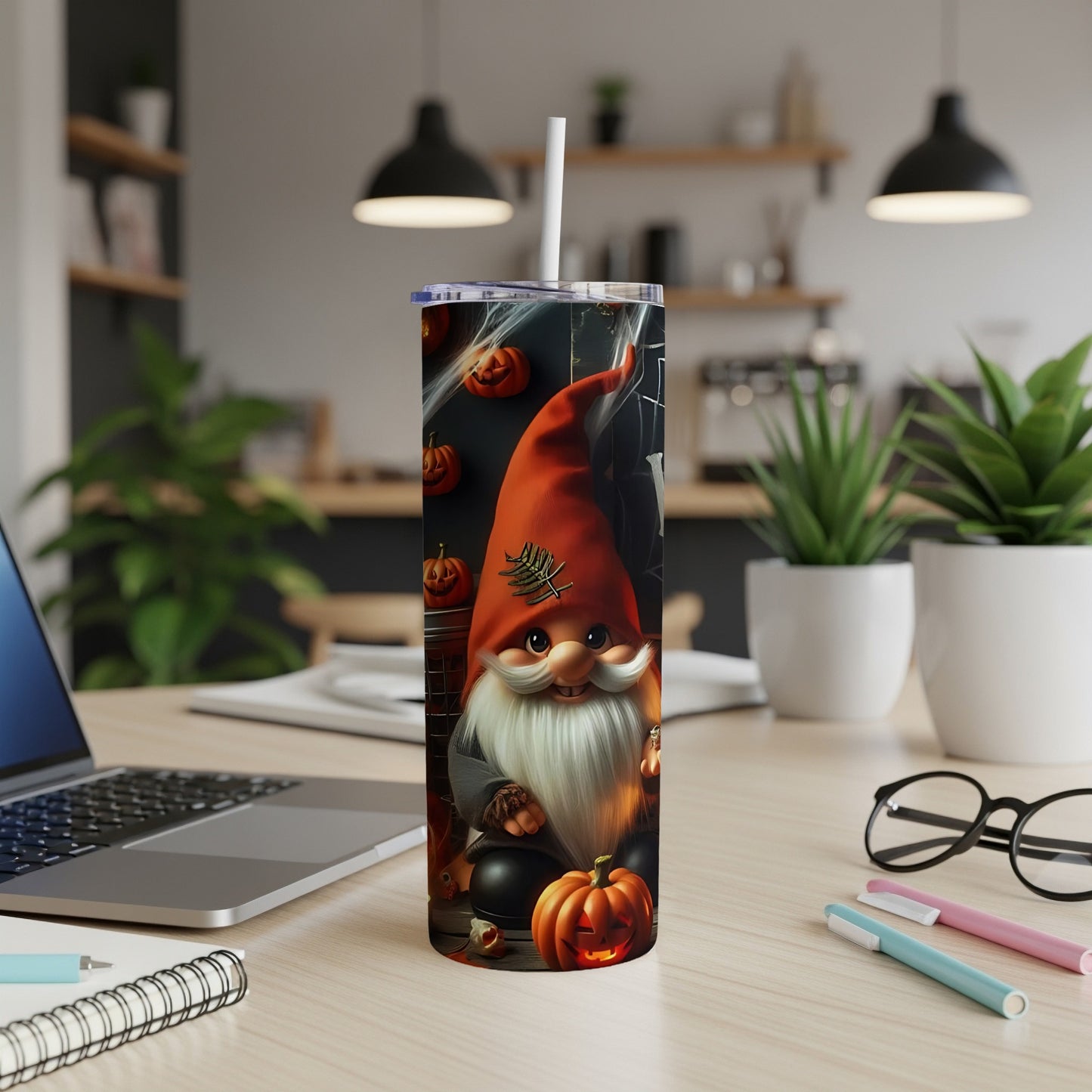 Tumbler with a Halloween gnome, pumpkins, and cobwebs on a desk.