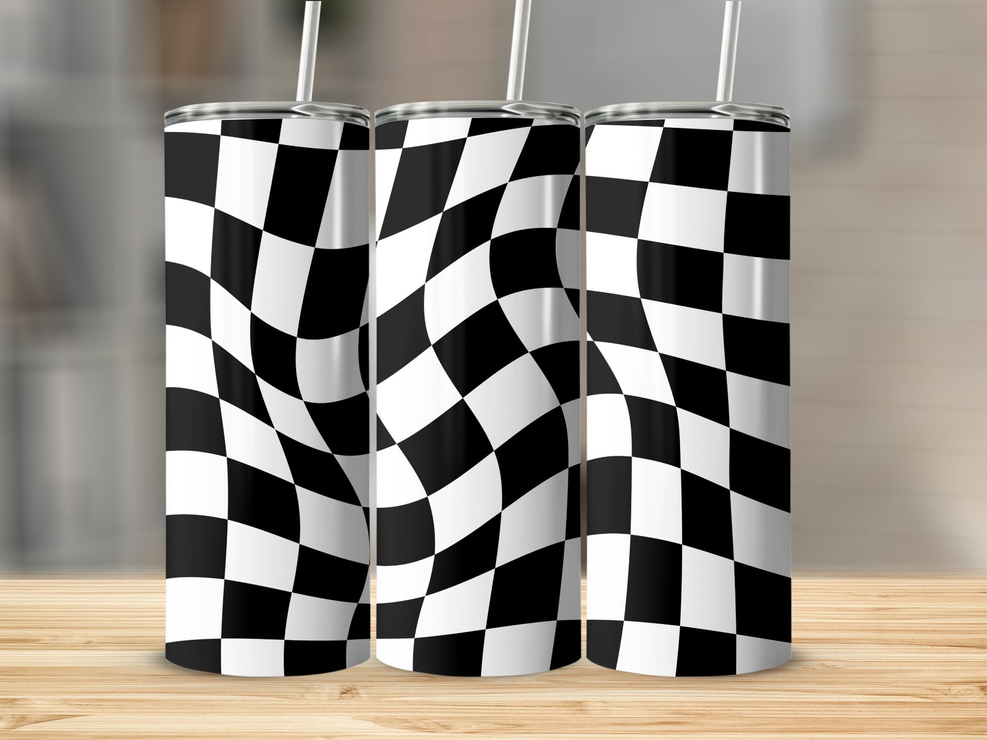 Three tumblers with a warped black and white checkered pattern and straws.