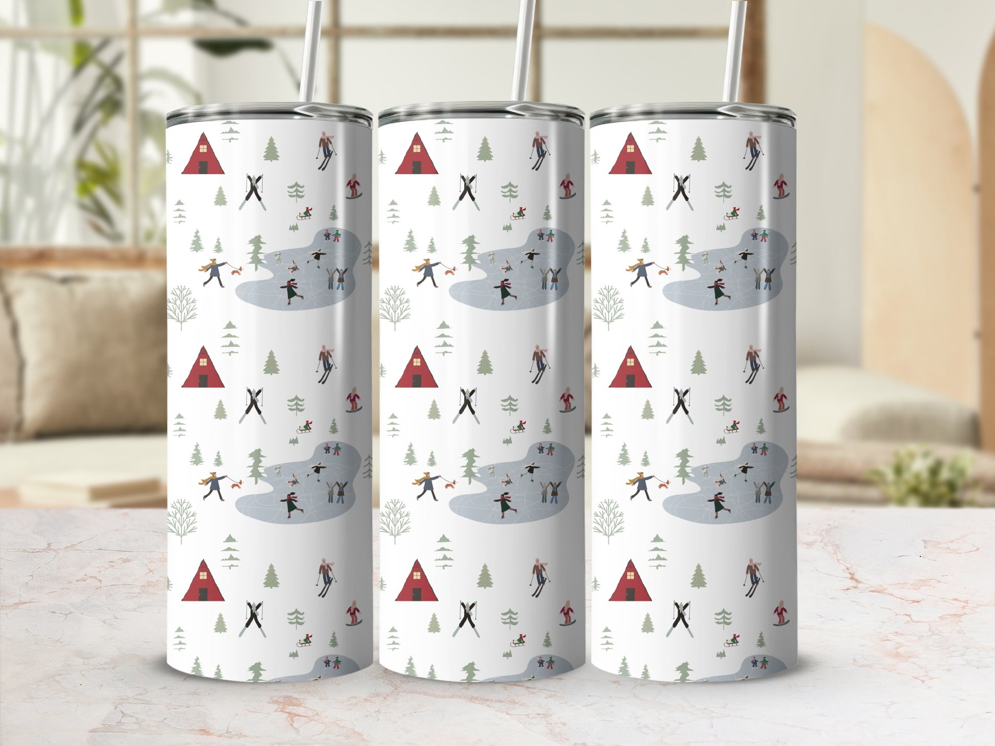 Three tumblers with a winter skating scene pattern on a marble surface.