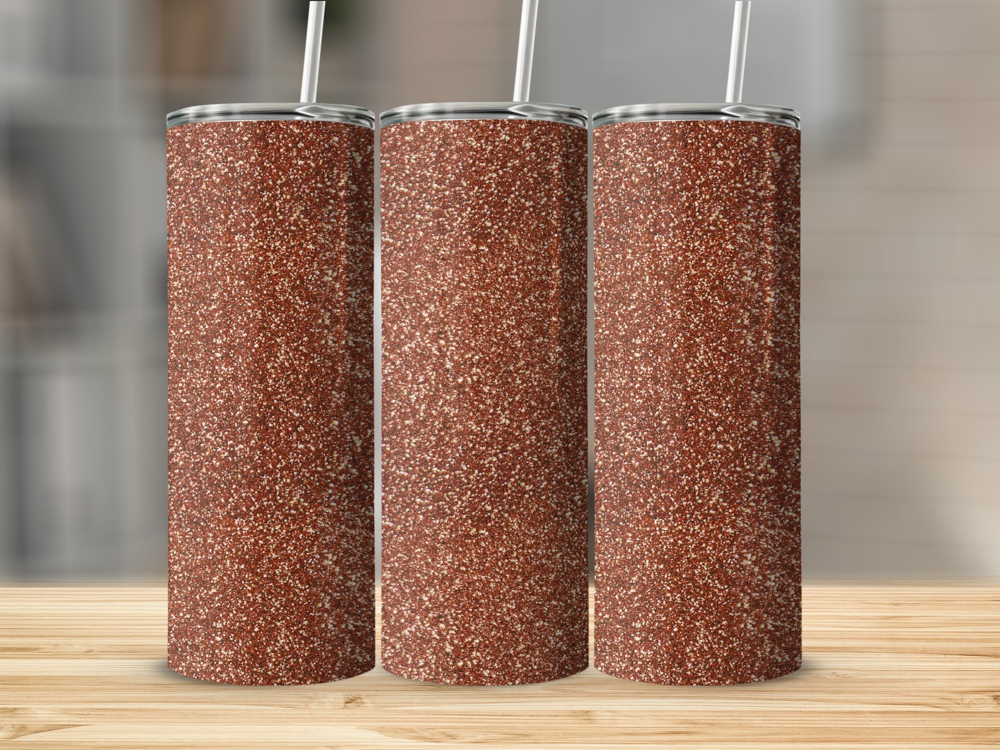 Three tumblers with a speckled brown glitter design and straws.