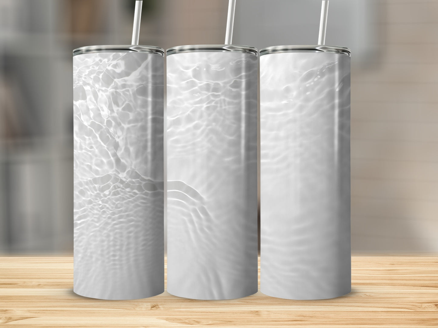 Three white tumblers with water ripple pattern on wooden surface.