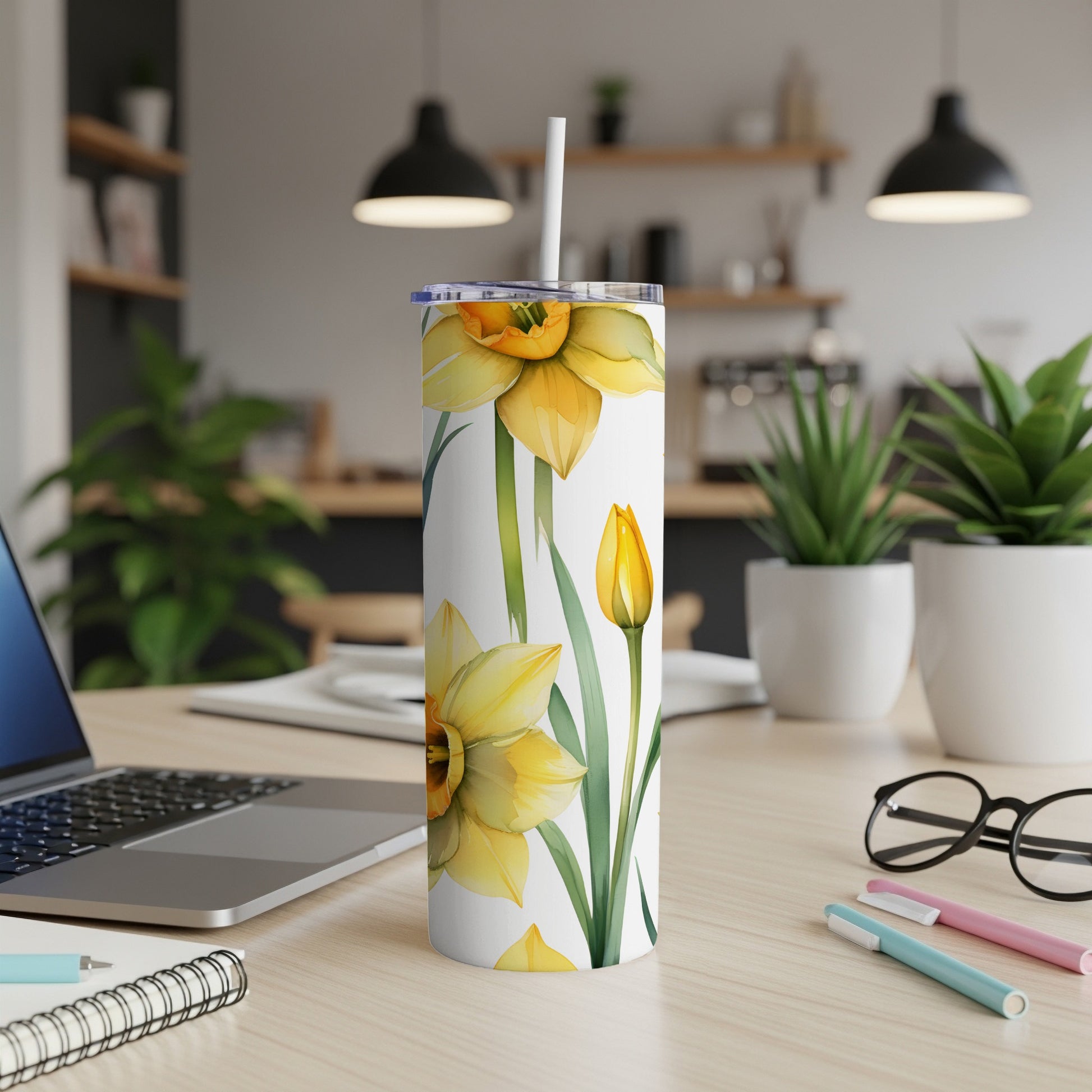 White tumbler with yellow daffodils and tulip illustration.