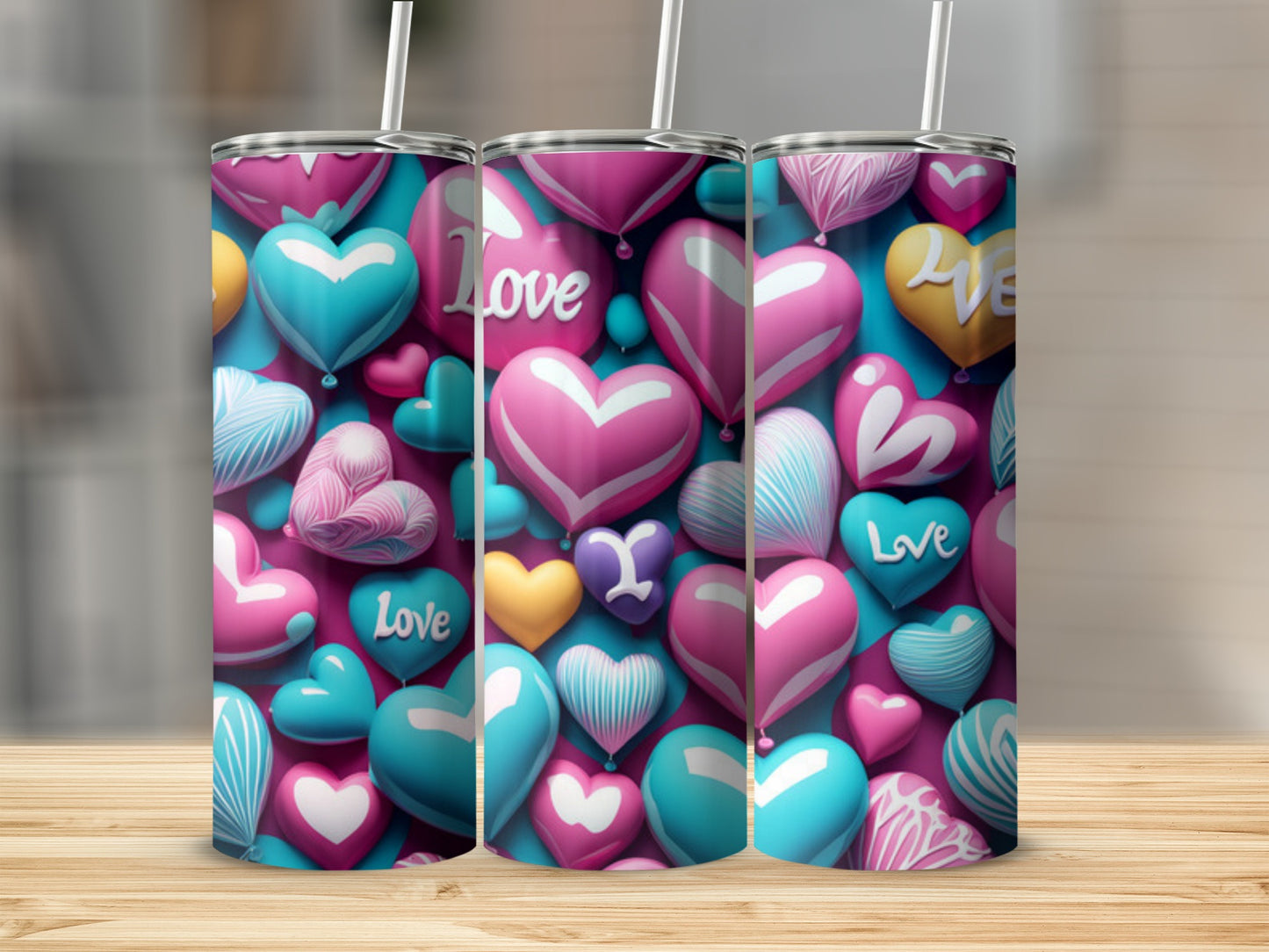Three heart-patterned tumblers with straws stand on a wooden surface.