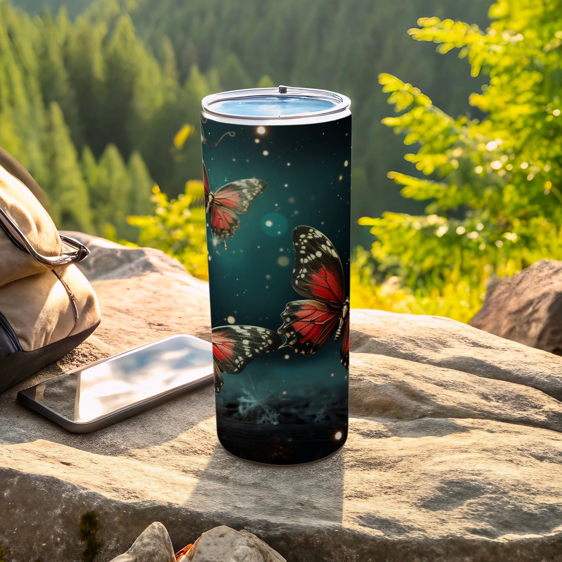 Tumbler with red butterflies and stars on a dark background.