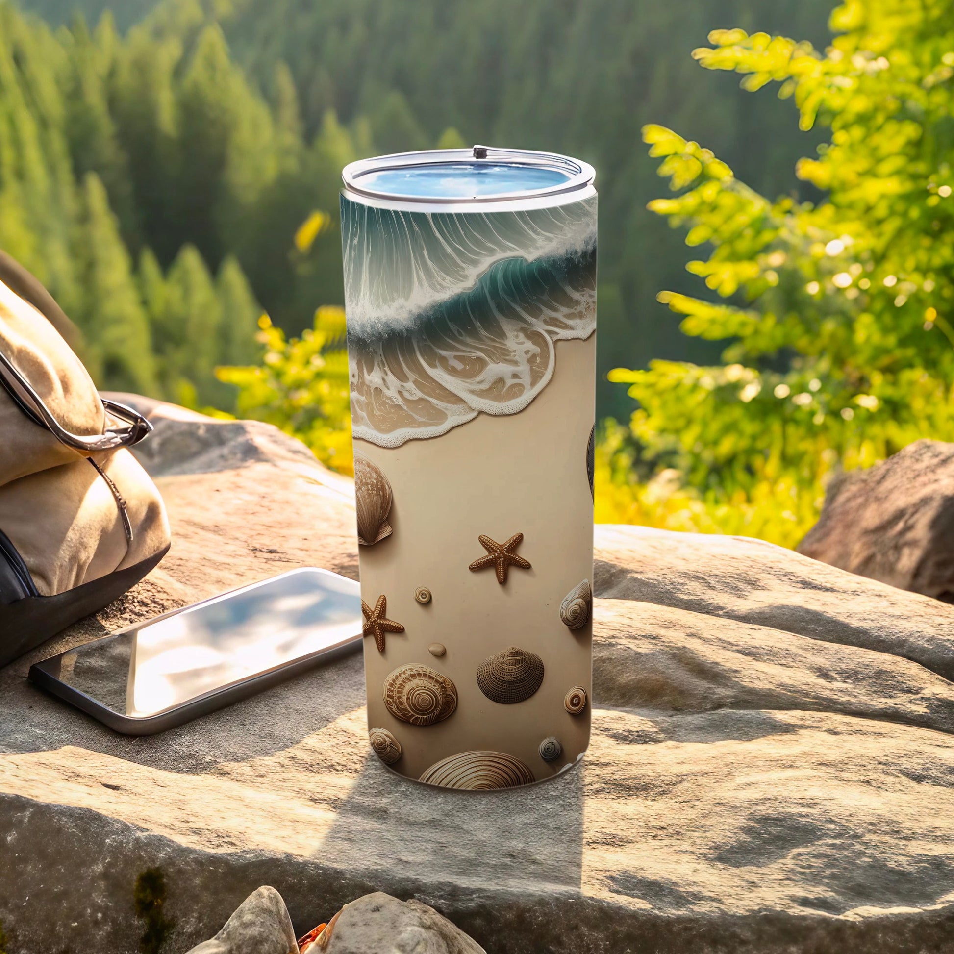 Tumbler with ocean waves, seashells, and starfish pattern on a rocky surface.