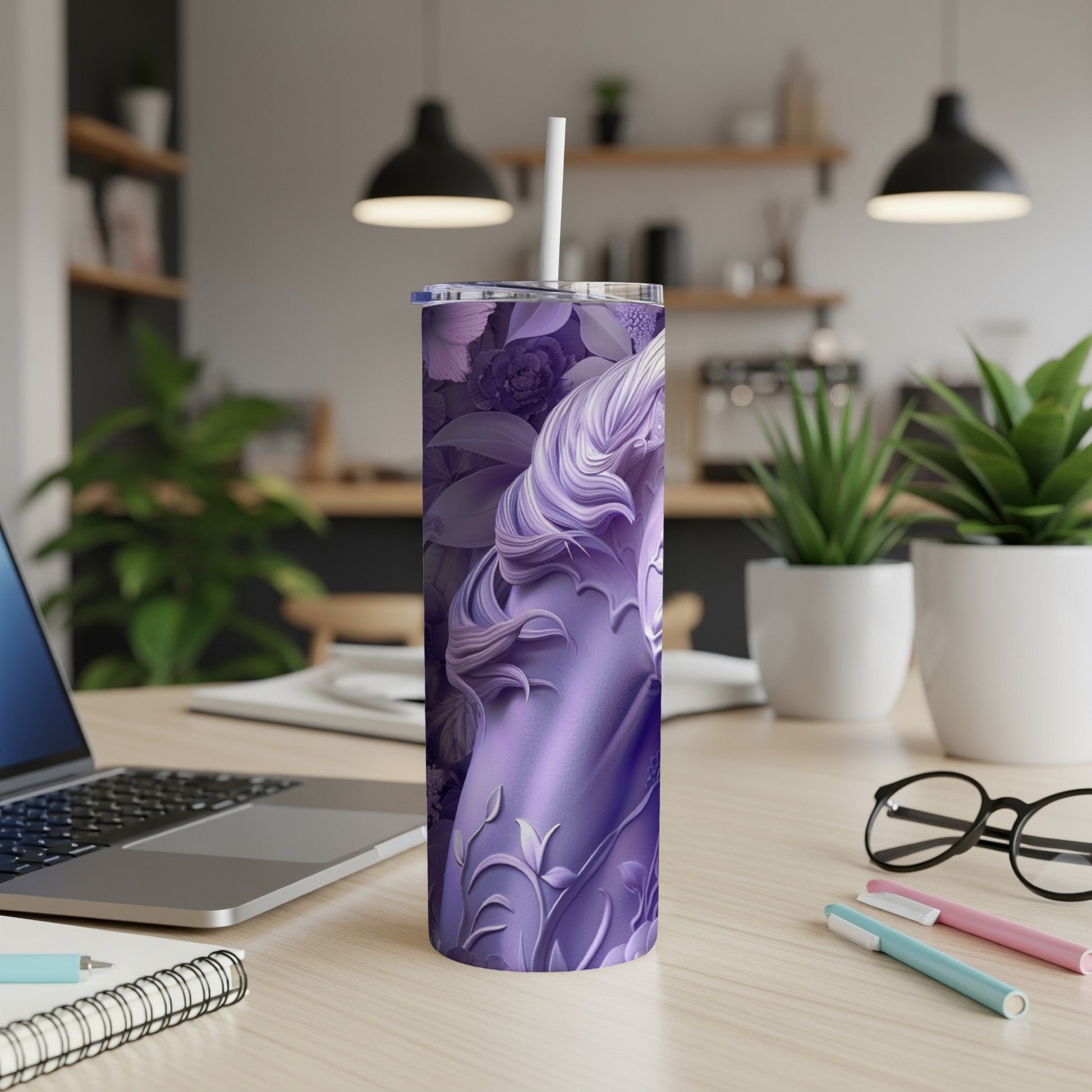 Purple tumbler with a swirling unicorn design and white straw on a desk.