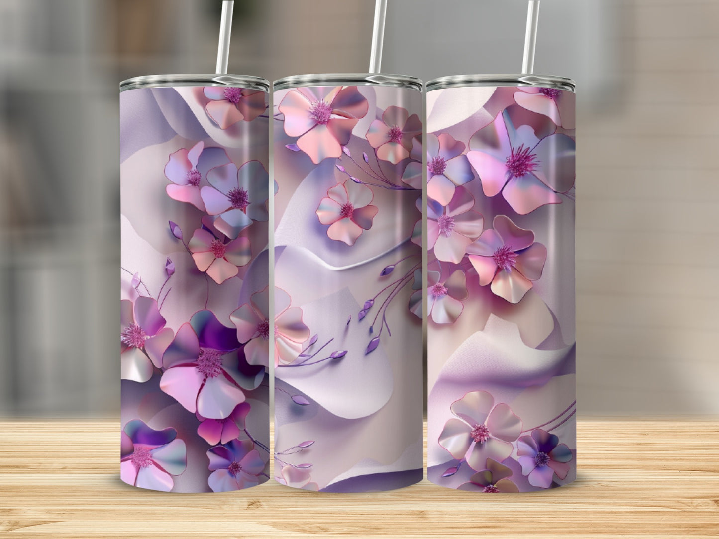 Three tumblers with a floral design of pink and purple flowers on a light background.
