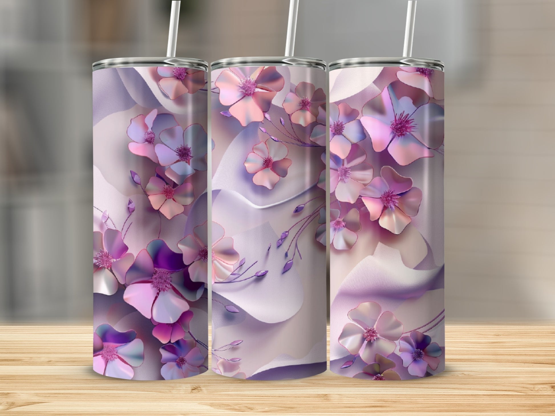 Three tumblers with a floral design of pink and purple flowers on a light background.